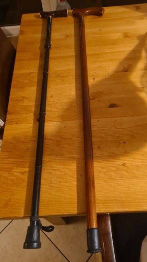 Walking Sticks. 1 X Classic Wood Walking Stick. And 1 X Metal Adjustable Walking Stick. Both In Good Condition.