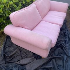 Large pink 2 seater sofa also large purple foot stool