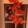 Pretty red vase with single artificial flower stem Image 3