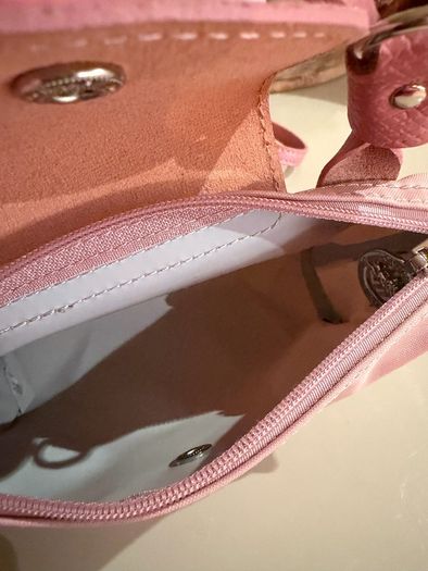pink Longchamp Le Pliage mini top-handle bag with a detachable shoulder strap