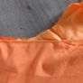 Solid orange satin look piece of fabric with beads Image 3