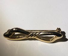 Gold bow shaped brooch