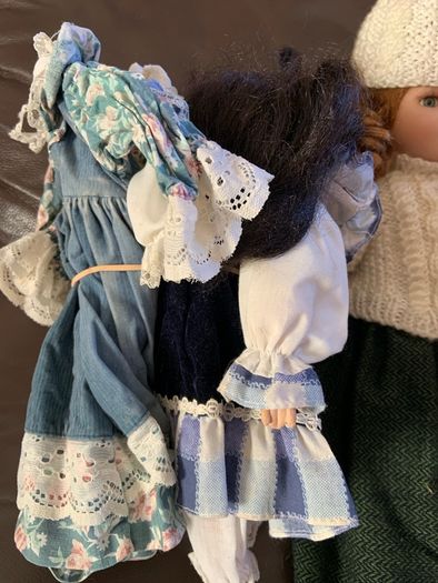 5 porcelain dolls with extra clothing perfect condition