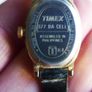 Vintage Timex womens quartz watch - gold tone oval case, white dial and black strap Image 7