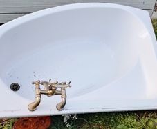 White Corner Bath with Traditional Brass Taps