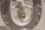 Rare find Cherub  Porcelain Horseshoe as flower vase held with child .