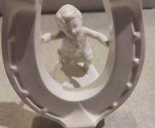 Rare find Cherub  Porcelain Horseshoe as flower vase held with child .
