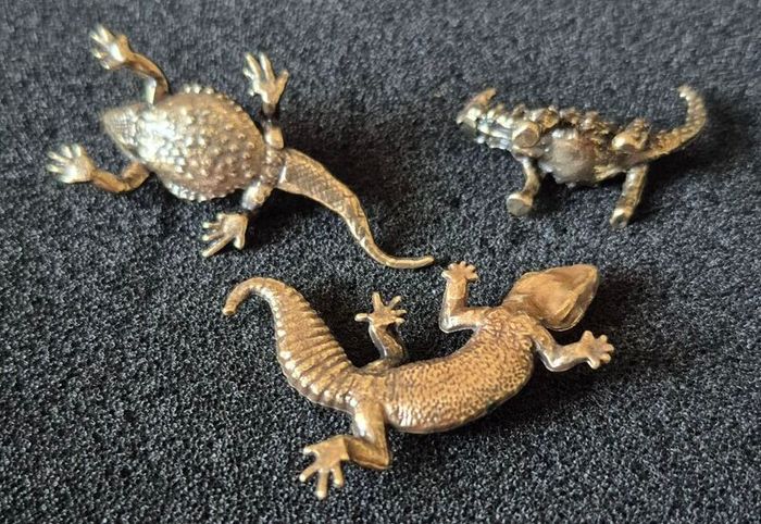 3 brass lizards.