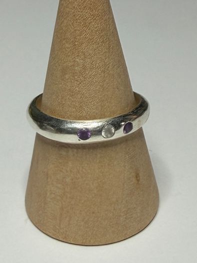 Handmade sterling silver ring with flush set stones. Size O