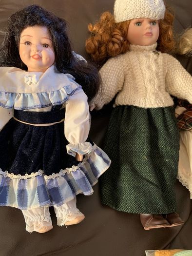 5 porcelain dolls with extra clothing perfect condition