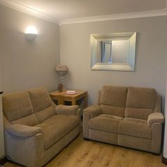 Pair of Parker Knoll 2 seater sofas with matching footstool