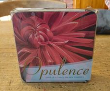 set of four Opulence brand square coasters featuring a vibrant red dahlia flower design. New in Package.