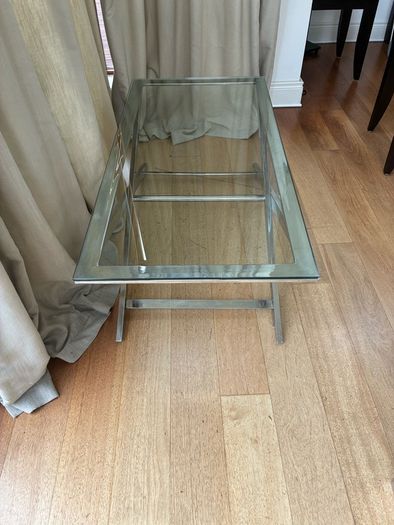 Contemporary glass top and polished metal coffee table