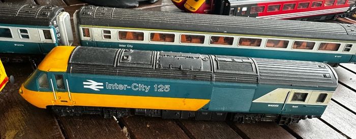 2 Hornby British rail engines and 2 British rail coaches. Don't have a controller so don't know if they work or not Hornby train