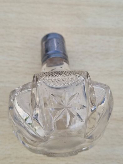 Vintage crystal bottle with silver top