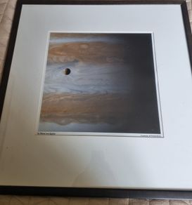 The famous NASA photograph titled "Io Moon over Jupiter"