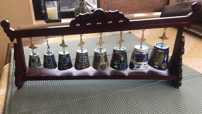 Enamel cloisonne graduated bells on wooden stand