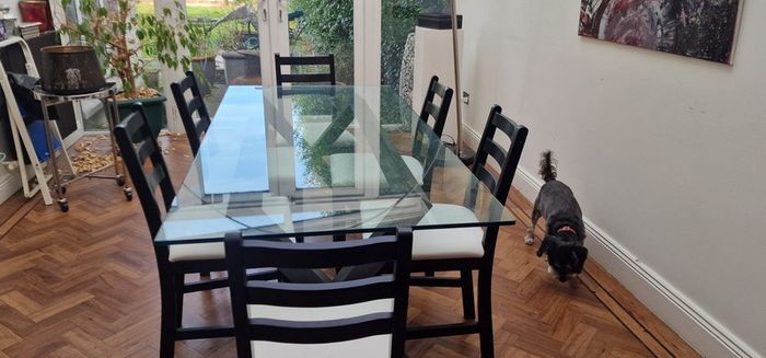 Glass and black wooden frame dining table with black & white chairs x6 or x8