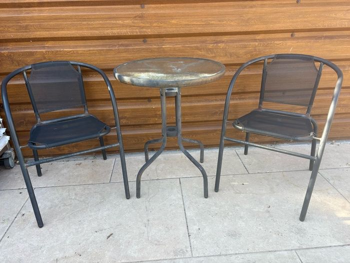 Small glass top garden table and x2 metal frame chairs