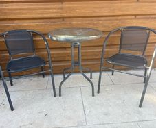 Small glass top garden table and x2 metal frame chairs