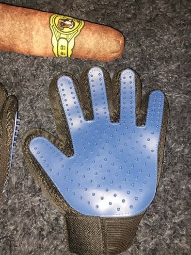 A pair of pet grooming and deshedding glove and Cigar designed toy for dogs