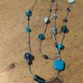 long necklace featuring a mix of blue-toned glass beads and silver-colored accent beads on a thin gray cord Image 2