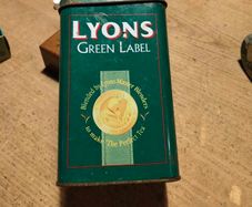 This vintage Lyons Green Label tea tin is a collectible item.