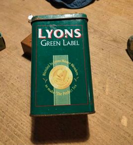 This vintage Lyons Green Label tea tin is a collectible item.