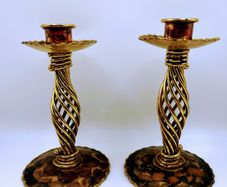 A pair of vintage brass spiral candle holders