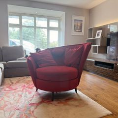 Red swivel accent chair