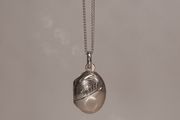 Small Sterling silver locket pendant on a silver chain