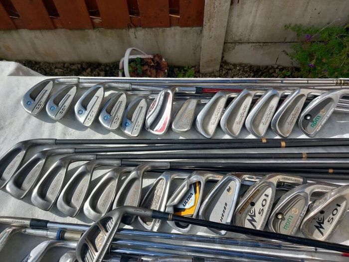 A selection of Golf clubs. Bags and golf balls.