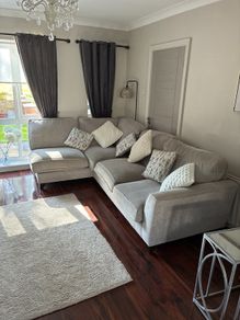 corner sofa in excellent condition poof to match