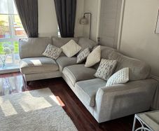corner sofa in excellent condition poof to match