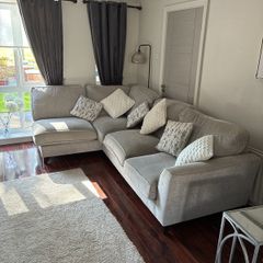 corner sofa in excellent condition poof to match