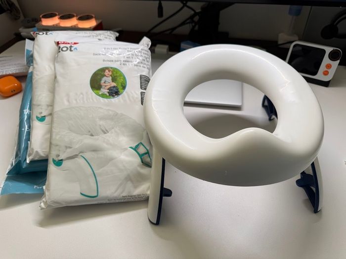 Oxo travel potty potty training foldable with 100 disposable bags