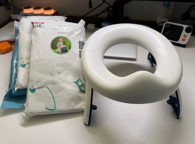 Oxo travel potty potty training foldable with 100 disposable bags
