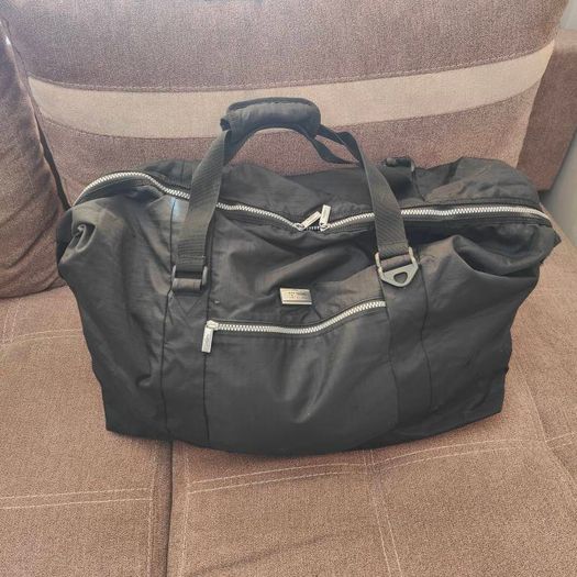 Large black expandable travel bag with shoulder strap