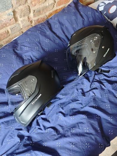 pair of helmets, one full face one open face