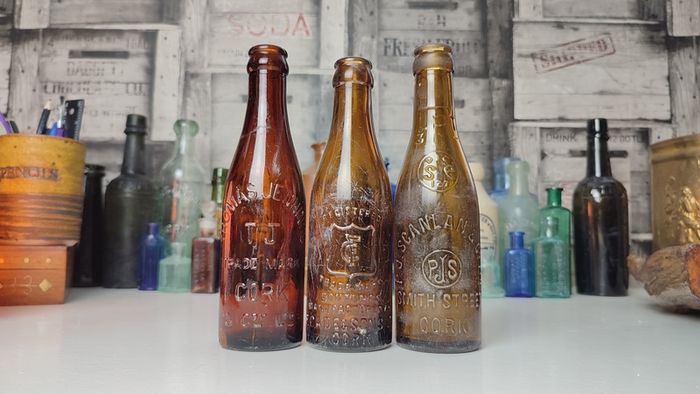 257 - Set of 3 Vintage Brown Glass Scanlan Cades Jennings Collectible Decorative Mineral Water Beer Bottles