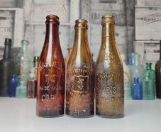 257 - Set of 3 Vintage Brown Glass Scanlan Cades Jennings Collectible Decorative Mineral Water Beer Bottles