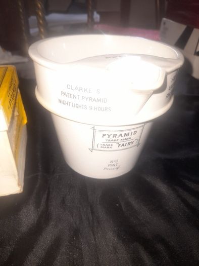 Clarkes Pyramid lamp night light and an Advertisment Box, comprising a white glazed ceramic reservoir marked Prices Patent Candle Company Limited, London