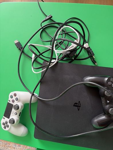 playstation 4 with two controllers and games