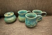 ceramic mugs and sugar bowl