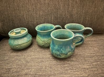 ceramic mugs and sugar bowl