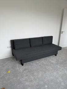 Dark grey sofa bed with storage