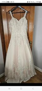 Wedding dress. Size 12. Brand new. Stunning dress! Heavily beaded. Fabulous pink underlay.