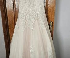 Wedding dress. Size 12. Brand new. Stunning dress! Heavily beaded. Fabulous pink underlay.