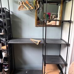 Large black wardrobe unit with shelves and hanging rail