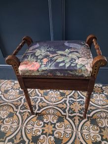 Antique piano stool upholstered in peacock fabric